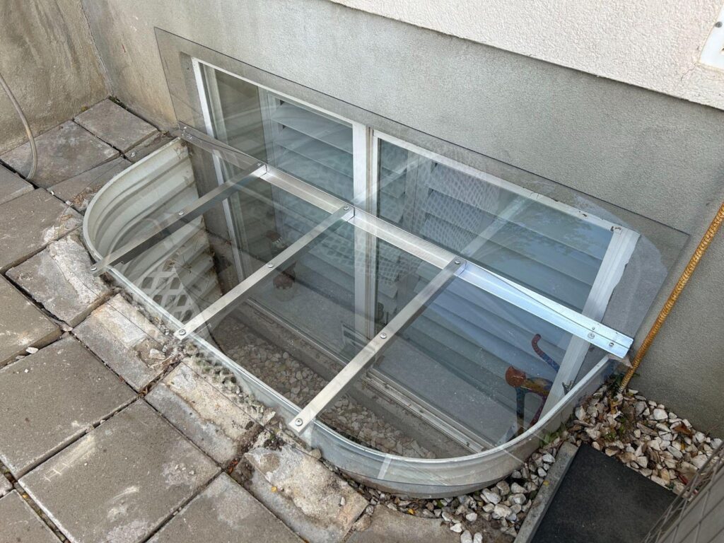 A house featuring a window beside a glass door showcasing a blend of natural light and architectural design
