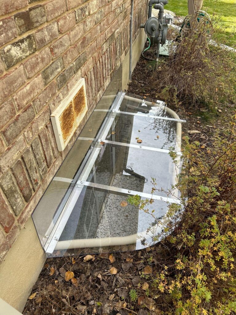 A house side displays a window adjacent to a glass door providing visibility and access to the home interior