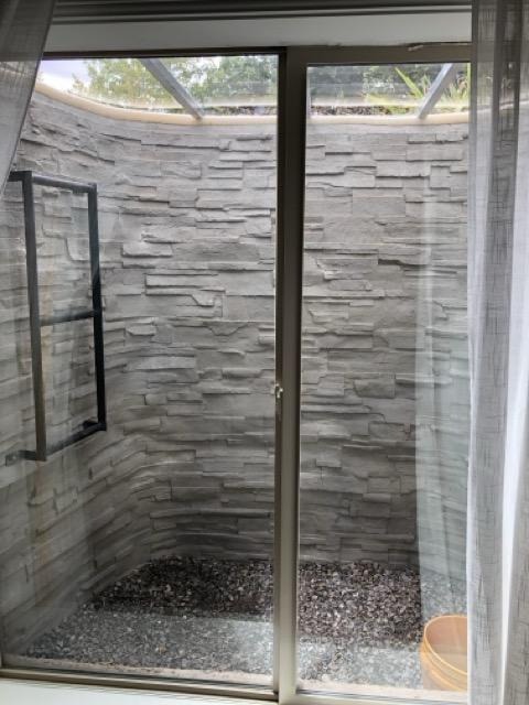A bathroom featuring a shower and a window, providing natural light and ventilation