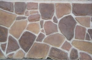 Rustic Mountain Light tan mortar background with a combination of rocks colored brown, red, light and dark tan.