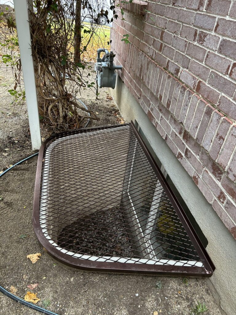 A metal grate on the ground, providing a sturdy and secure covering for an opening or pathway.