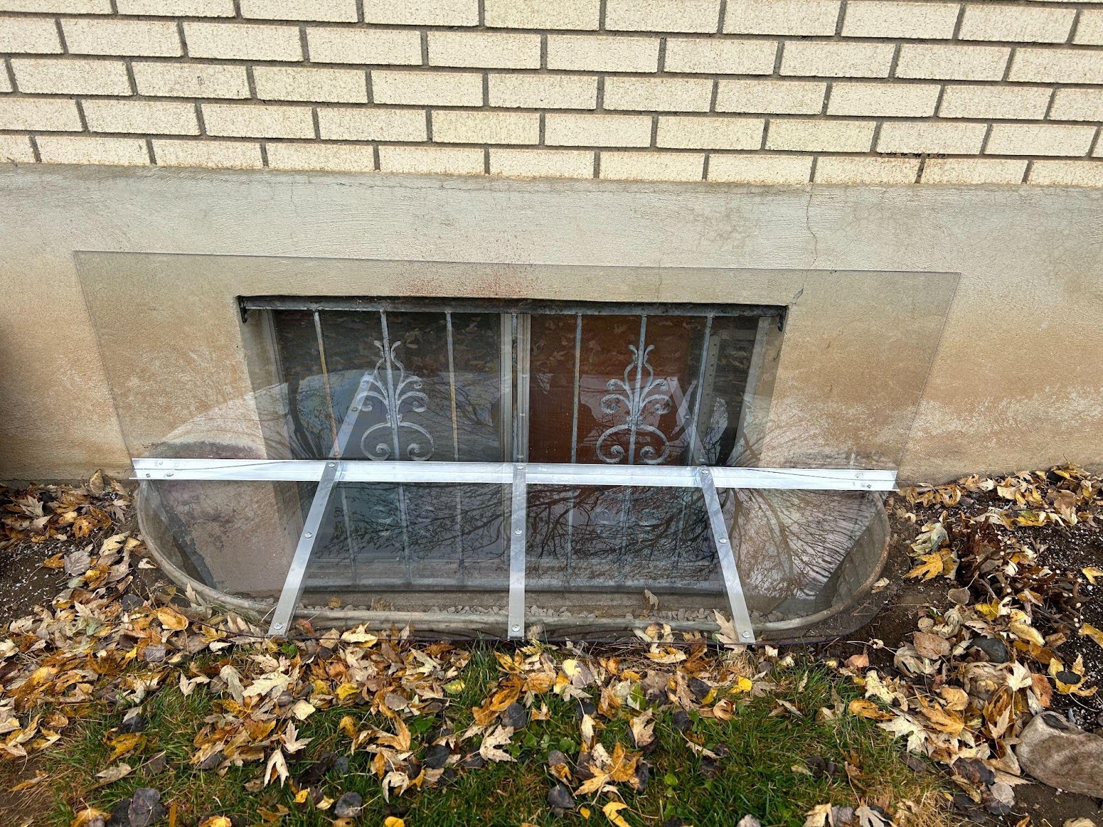 A damaged window displaying a broken glass pane with visible cracks and pieces missing from the frame
