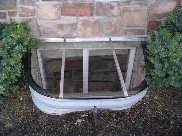 A metal building featuring a single window with a sturdy window frame